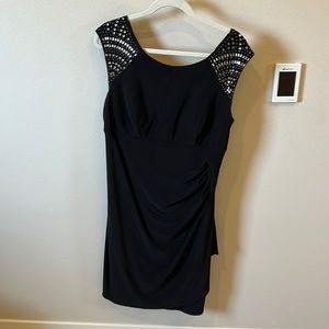 Figure flattering cocktail dress with mirrored shoulder detail. Size 14